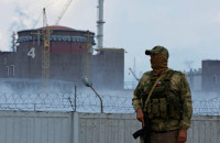 FILE PHOTO: A serviceman with a Russian flag on his uniform stands guard near the Zaporizhzhia Nuclear Power Plant in the course of Ukraine-Russia conflict outside the Russian-controlled city of Enerhodar in the Zaporizhzhia region, Ukraine August 4, 2022