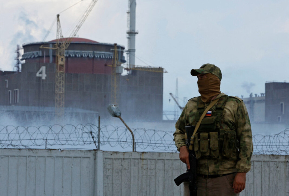 FILE PHOTO: A serviceman with a Russian flag on his uniform stands guard near the Zaporizhzhia Nuclear Power Plant in the course of Ukraine-Russia conflict outside the Russian-controlled city of Enerhodar in the Zaporizhzhia region, Ukraine August 4, 2022 FILE PHOTO: A serviceman with a Russian flag on his uniform stands guard near the Zaporizhzhia Nuclear Power Plant in the course of Ukraine-Russia conflict outside the Russian-controlled city of Enerhodar in the Zaporizhzhia region, Ukraine August 4, 2022